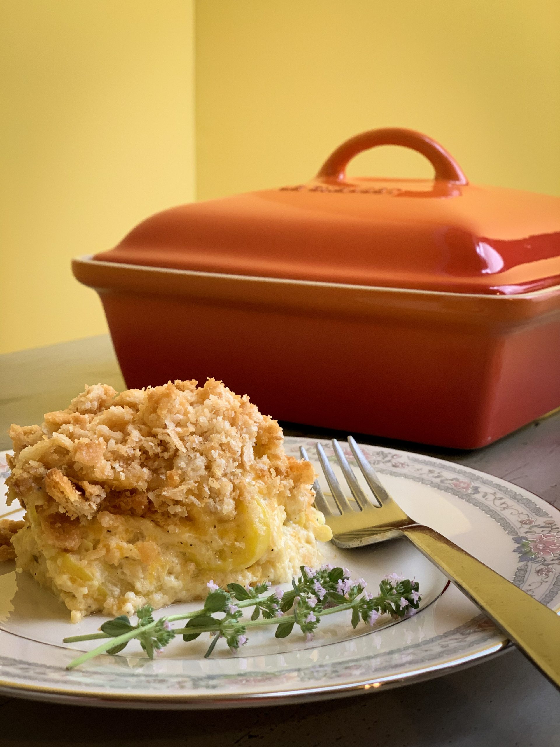 https://www.thisgalcooks.com/wp-content/uploads/2021/05/one-helping-of-squash-casserole-with-le-creuset-casserole-dish-scaled.jpg